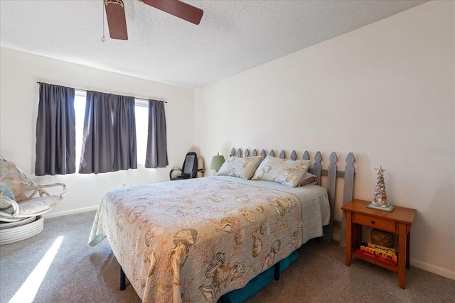 bedroom featuring ceiling fan, carpet floors, and a textured ceiling