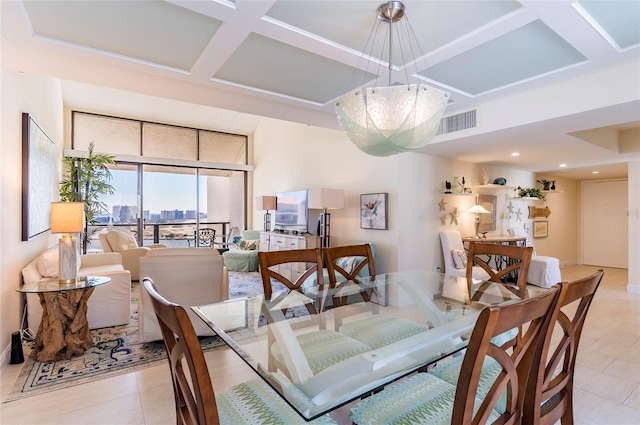 dining space featuring light tile patterned floors and coffered ceiling