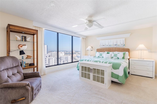 carpeted bedroom featuring a textured ceiling and ceiling fan
