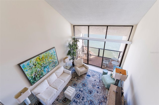 living room featuring a wall of windows and a textured ceiling