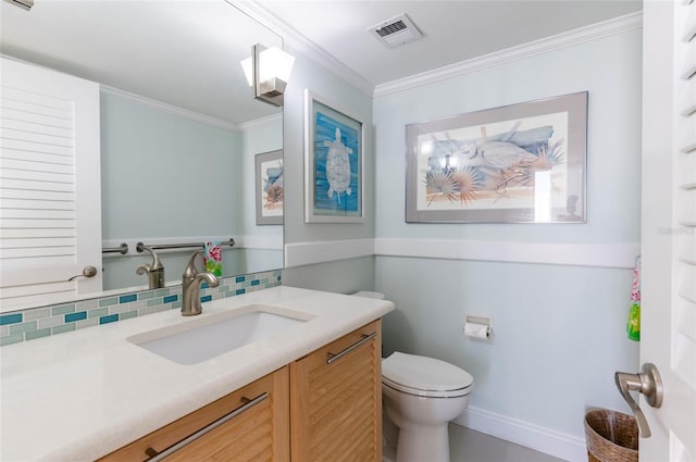 bathroom with vanity, toilet, ornamental molding, and backsplash