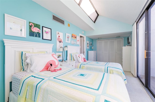 carpeted bedroom with a closet and lofted ceiling