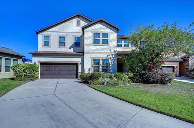 view of front of house featuring a front yard and a garage