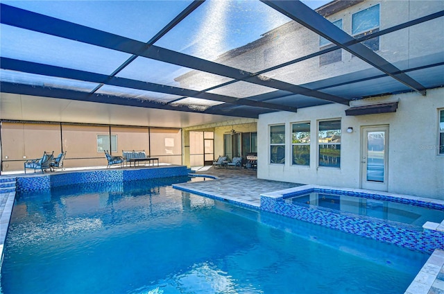 view of pool with an in ground hot tub, a patio area, and a lanai