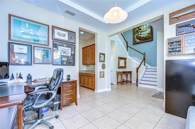 tiled office featuring a textured ceiling