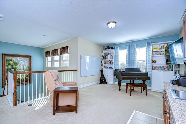 sitting room featuring light carpet and plenty of natural light