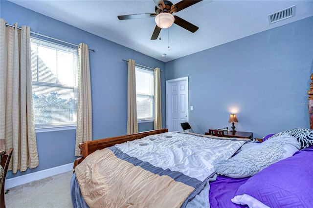 bedroom with ceiling fan and light colored carpet