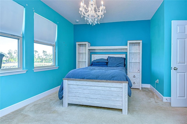 bedroom with a notable chandelier and light colored carpet