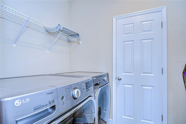 washroom with washing machine and clothes dryer