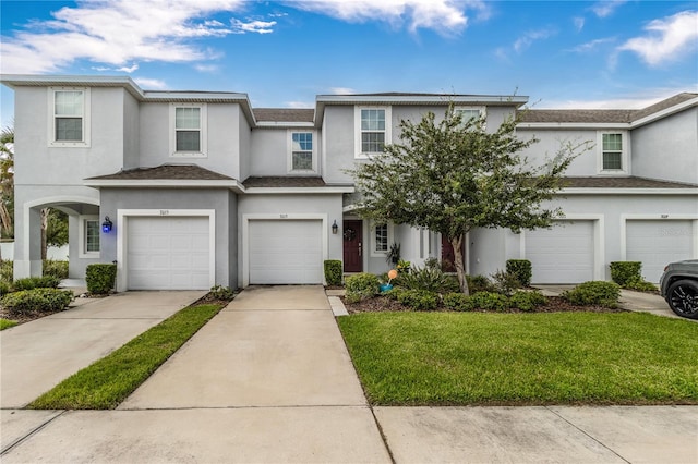 view of front of home with a front lawn and a garage