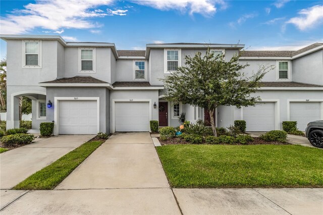 7013 Summer Holly Pl, Riverview, FL 33578 - view of property featuring a garage, stucco siding, a front yard, and driveway