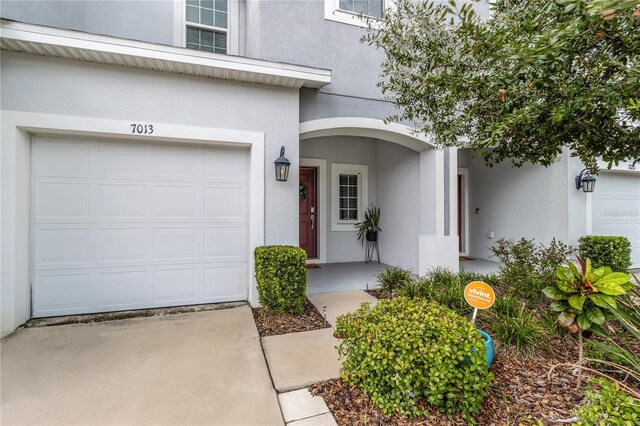 7013 Summer Holly Pl, Riverview, FL 33578 - view of exterior entry featuring stucco siding and a garage