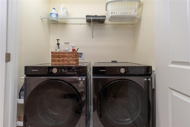 laundry area with washing machine and clothes dryer