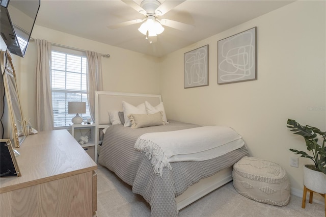 bedroom featuring light colored carpet and ceiling fan