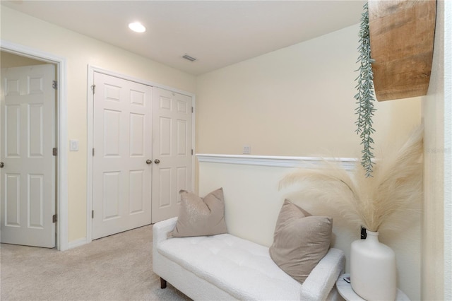 living area with light colored carpet