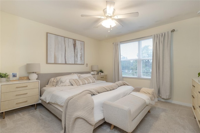 bedroom featuring ceiling fan and light colored carpet