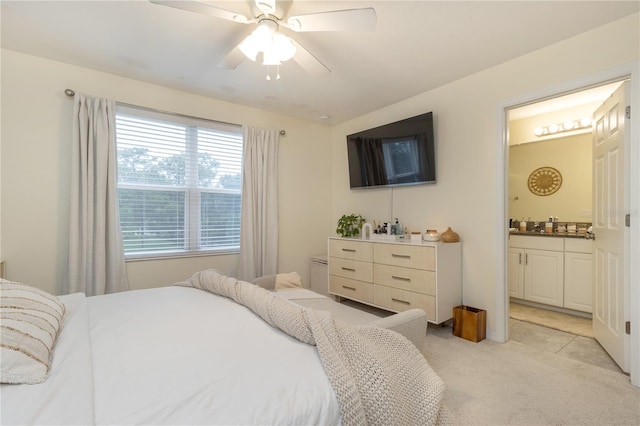 carpeted bedroom featuring connected bathroom and ceiling fan