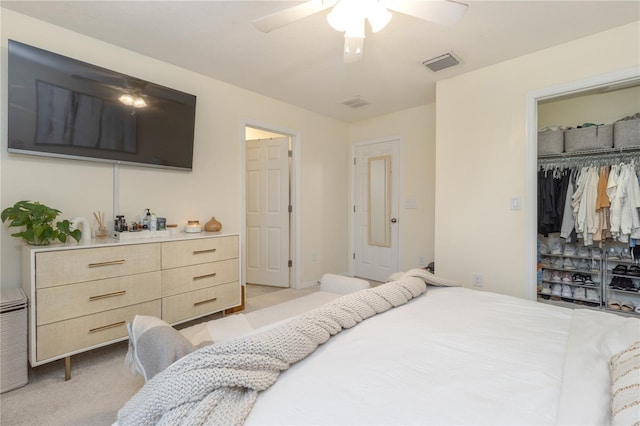 bedroom featuring a closet, light colored carpet, and ceiling fan