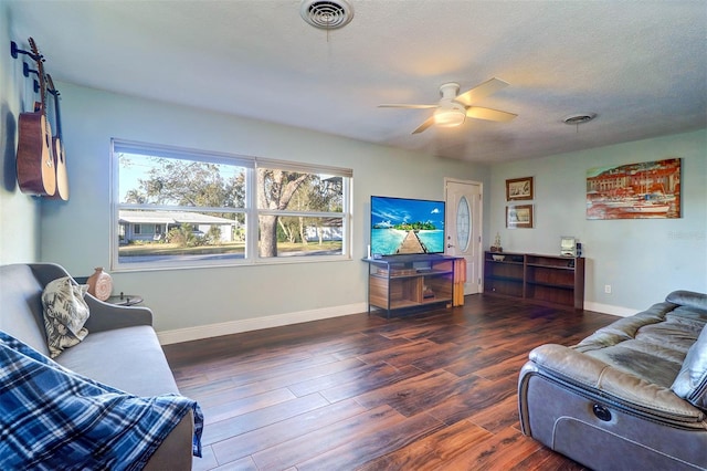 living room featuring a textured ceiling, dark hardwood / wood-style flooring, and ceiling fan