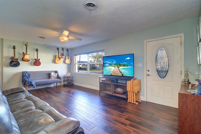 living room with ceiling fan, dark wood-type flooring, and a textured ceiling