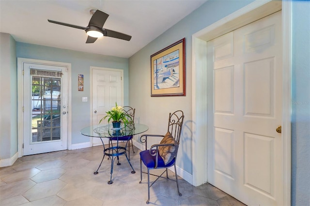 dining area featuring ceiling fan and light tile patterned flooring