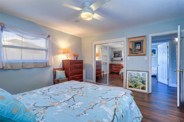 bedroom featuring a closet, dark wood-type flooring, and ceiling fan