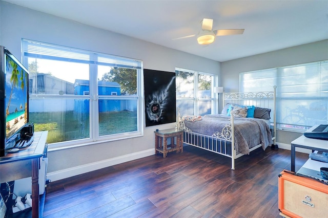 bedroom with dark hardwood / wood-style flooring and ceiling fan