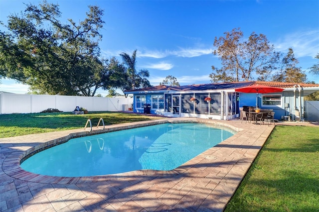 view of swimming pool featuring a lawn and a patio