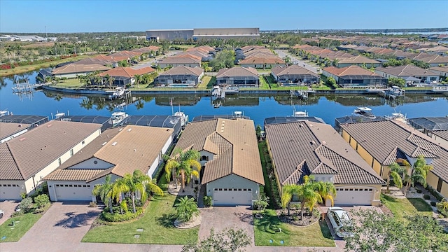 drone / aerial view featuring a water view and a residential view