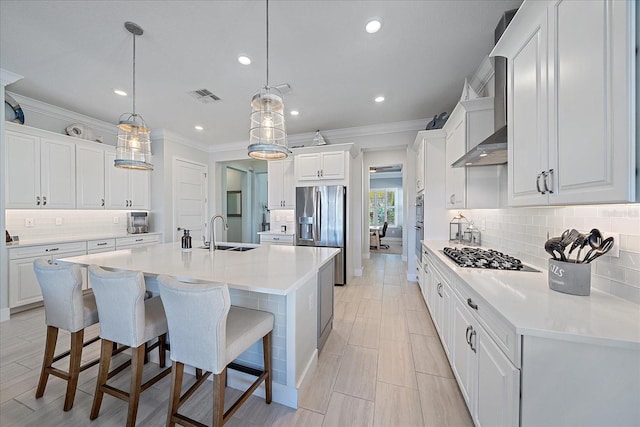 kitchen with white cabinetry, pendant lighting, and appliances with stainless steel finishes