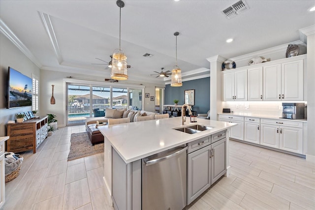 kitchen with white cabinets, dishwasher, a center island with sink, and sink