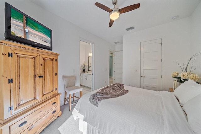 bedroom featuring ensuite bathroom, ceiling fan, light colored carpet, and a closet