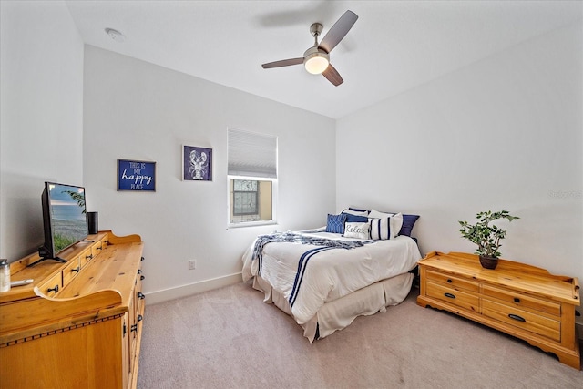 bedroom featuring light colored carpet and ceiling fan