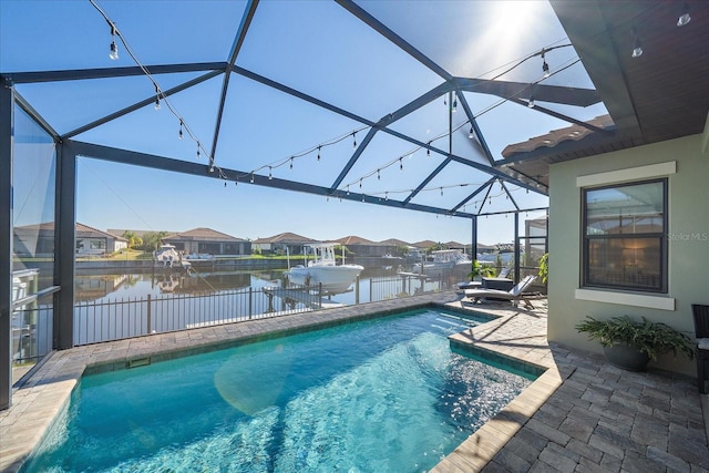 view of pool with a lanai, a water view, and a patio