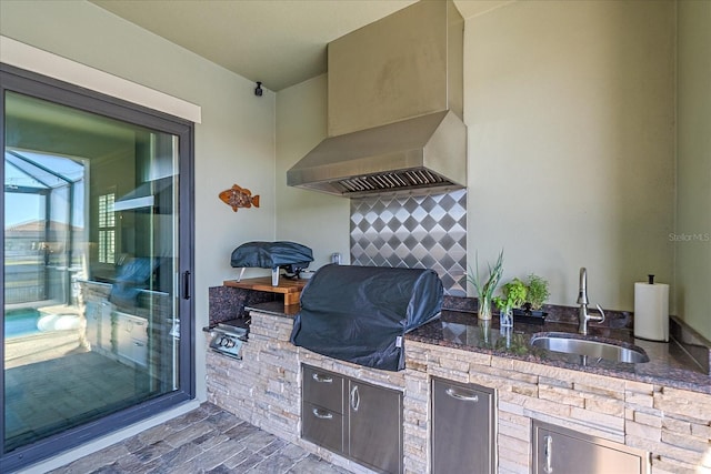 view of patio / terrace with area for grilling, a grill, and sink