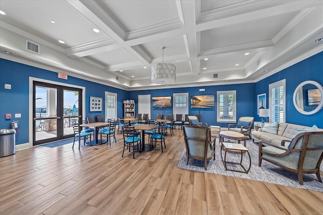 interior space featuring beam ceiling, light hardwood / wood-style floors, an inviting chandelier, and crown molding