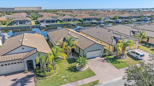 bird's eye view with a water view and a residential view