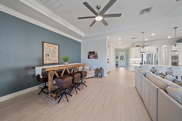 dining area featuring visible vents, crown molding, baseboards, and ceiling fan