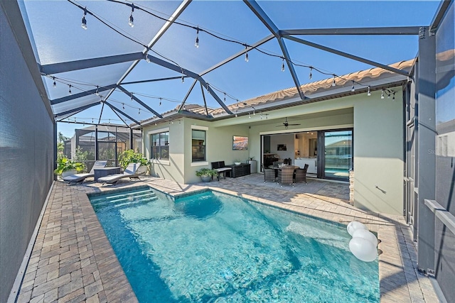 outdoor pool with glass enclosure, a patio area, ceiling fan, and an outdoor living space