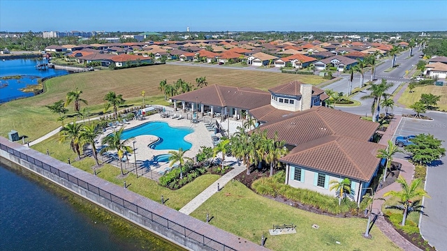 drone / aerial view featuring a water view and a residential view