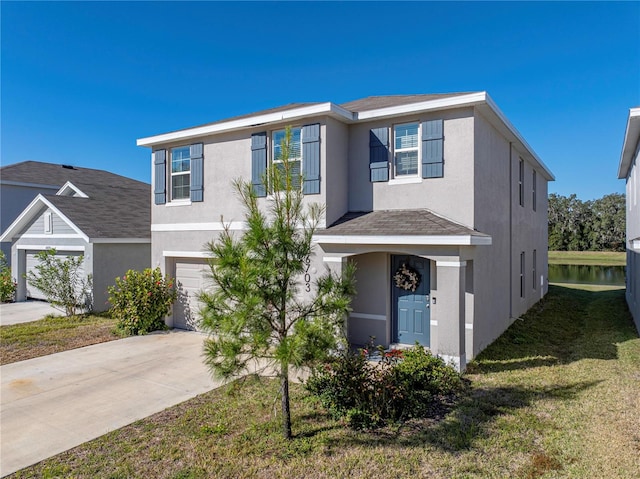 view of front of house with a garage and a front lawn