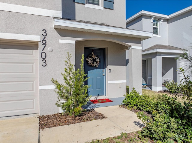 view of exterior entry featuring a garage