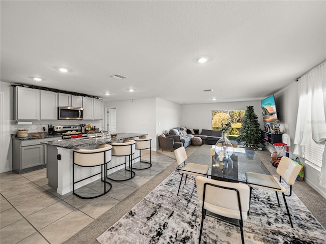 tiled dining area featuring a textured ceiling