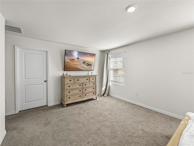 unfurnished bedroom featuring carpet and a textured ceiling