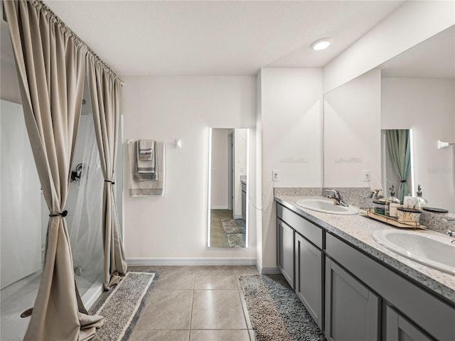 bathroom featuring tile patterned floors, vanity, and walk in shower