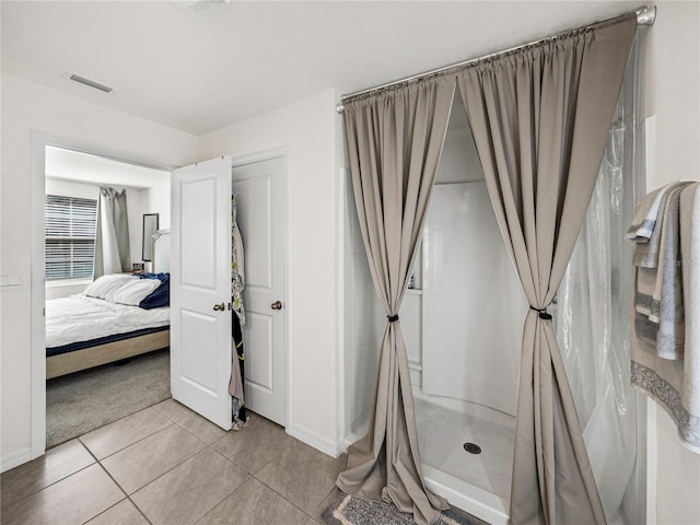 bathroom with a shower with shower curtain and tile patterned floors