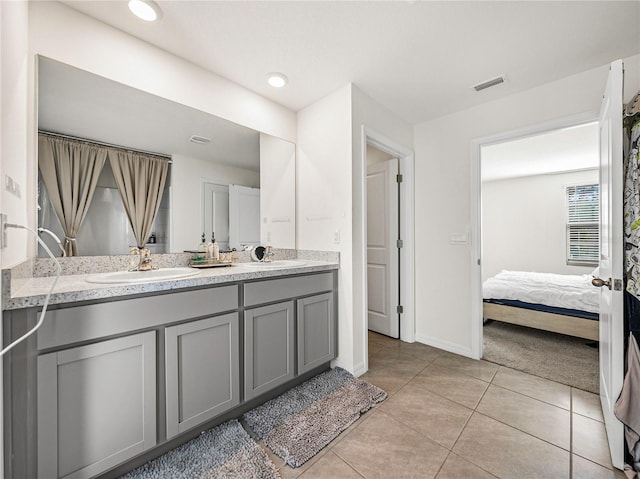 bathroom featuring tile patterned flooring and vanity