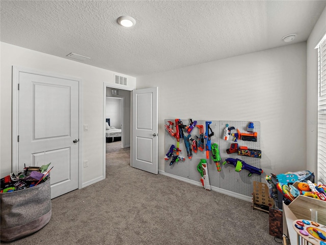 game room featuring carpet and a textured ceiling