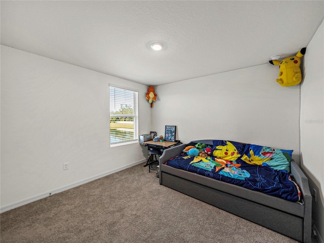 bedroom featuring carpet flooring and a textured ceiling