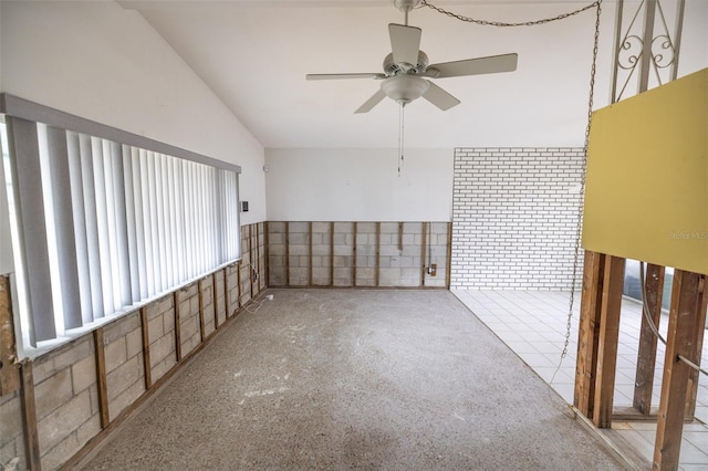 unfurnished room with ceiling fan, plenty of natural light, and lofted ceiling